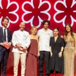 Cerimônia do Guia Michelin Brasil 2026 com chefs premiados e representantes no palco diante do símbolo das três estrelas