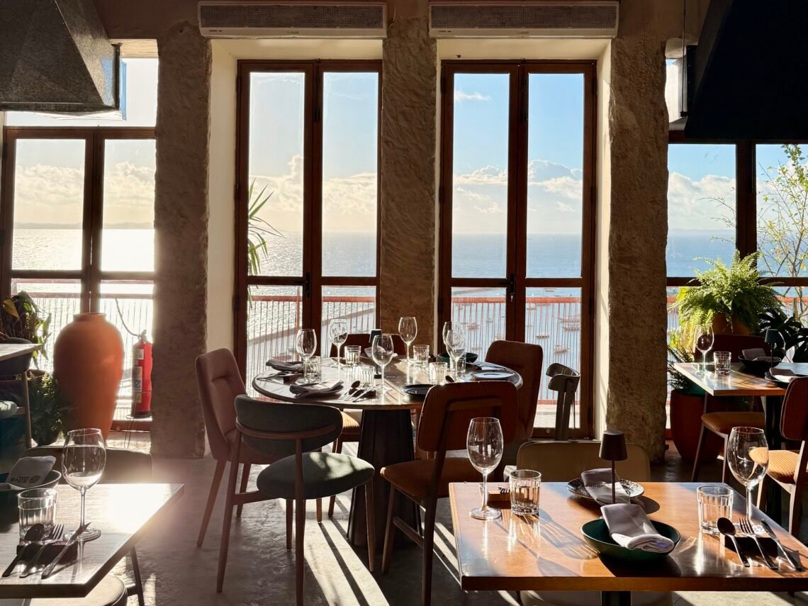 Salão do restaurante Silva Cozinha, na Rua Chile, em Salvador, com mesas postas e vista para a Baía de Todos-os-Santos.